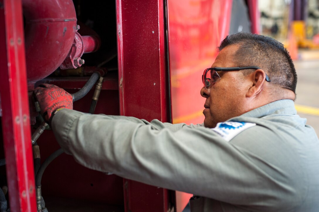 Tony Mojica, 47th Logistics Readiness Division automobile and fire truck technician, checks a fire truck’s pressure gauge at Laughlin Air Force Base, Texas, July 22, 2013. The 47th LRD vehicle maintenance shop is responsible for repairing all 127 government-owned vehicles on base. (U.S. Air Force photo/Senior Airman John D. Partlow)