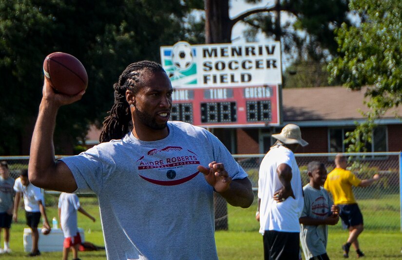 Larry Fitzgerald, Arizona Cardinals wide receiver, throws a football during the Andre Roberts ProCamp July 16, 2013, at Joint Base Charleston - Weapons Station, S.C. More than 100 base children attended the camp held July 15 and16, and participated in fundamental football drills. Small groups ensured each camper received maximum instruction from the area’s top football coaches. Roberts funded the camp, enabling children to attend for free.  (U.S. Air Force photo/ Senior Airman Jared Trimarchi)