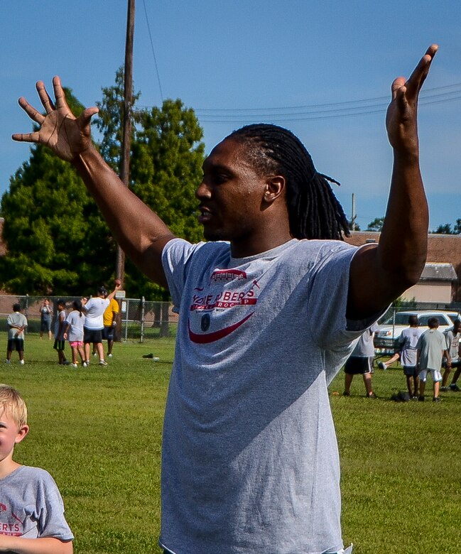 Roddy White, Atlanta Falcons wide receiver, reacts to a play during the Andre Roberts ProCamp July 15, 2013, at Joint Base Charleston - Weapons Station, S.C. More than 100 base children attended the camp held July 15 and16, and participated in fundamental football drills. Small groups ensured each camper received maximum instruction from the area’s top football coaches. Roberts funded the camp, enabling children to attend for free.  (U.S. Air Force photo/ Senior Airman Jared Trimarchi)