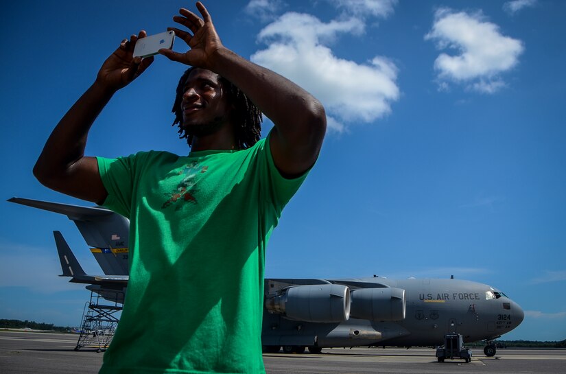 Andre Roberts, Arizona Cardinals wide receiver, takes a photo of a C-17 Globemaster III July 16, 2013, at Joint Base Charleston – Air Base, S.C. Roberts was visiting Charleston to host the Andre Roberts ProCamp July 15-16 at the JB Charleston – Weapons Station. More than 100 base children attended the camp and participated in fundamental football drills. Small groups ensured each camper received maximum instruction from the area’s top football coaches. Roberts funded the camp, enabling children to attend for free.  (U.S. Air Force photo/ Senior Airman Jared Trimarchi)