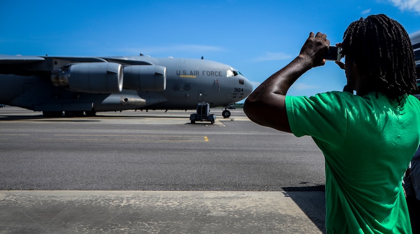 Andre Roberts, Arizona Cardinals wide receiver, takes a photo of a C-17 Globemaster III July 16, 2013, at Joint Base Charleston – Air Base. Roberts was visiting Charleston to host the Andre Roberts ProCamp July 15 and16 at the JB Charleston – Weapons Station, S.C. More than 100 base children attended the camp and participated in fundamental football drills. Small groups ensured each camper received maximum instruction from the area’s top football coaches. Roberts funded the camp, enabling children to attend for free.  (U.S. Air Force photo/ Senior Airman Jared Trimarchi)