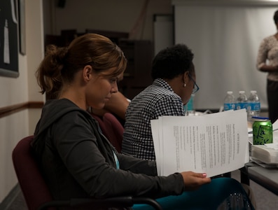 Capt. Audrey McCabe, 15th Airlift Squadron pilot, reviews paperwork during a Sexual Assault Prevention and Response class. McCabe attended the class along with 13 other soon-to-be Victim Advocates July 24, 2013, at Joint Base Charleston – Air Base, S.C. SARCs and VAs are available at major Department of Defense installations to assist victims of sexual assault. The JB Charleston SARC can be reached at 843-963-7272 and DOD has a 24-hour hotline at 1-800-342-9647. (U.S. Air Force photo/Senior Airman Ashlee Galloway)1-800-342-9647. (U.S. Air Force photo/Senior Airman Ashlee Galloway)
