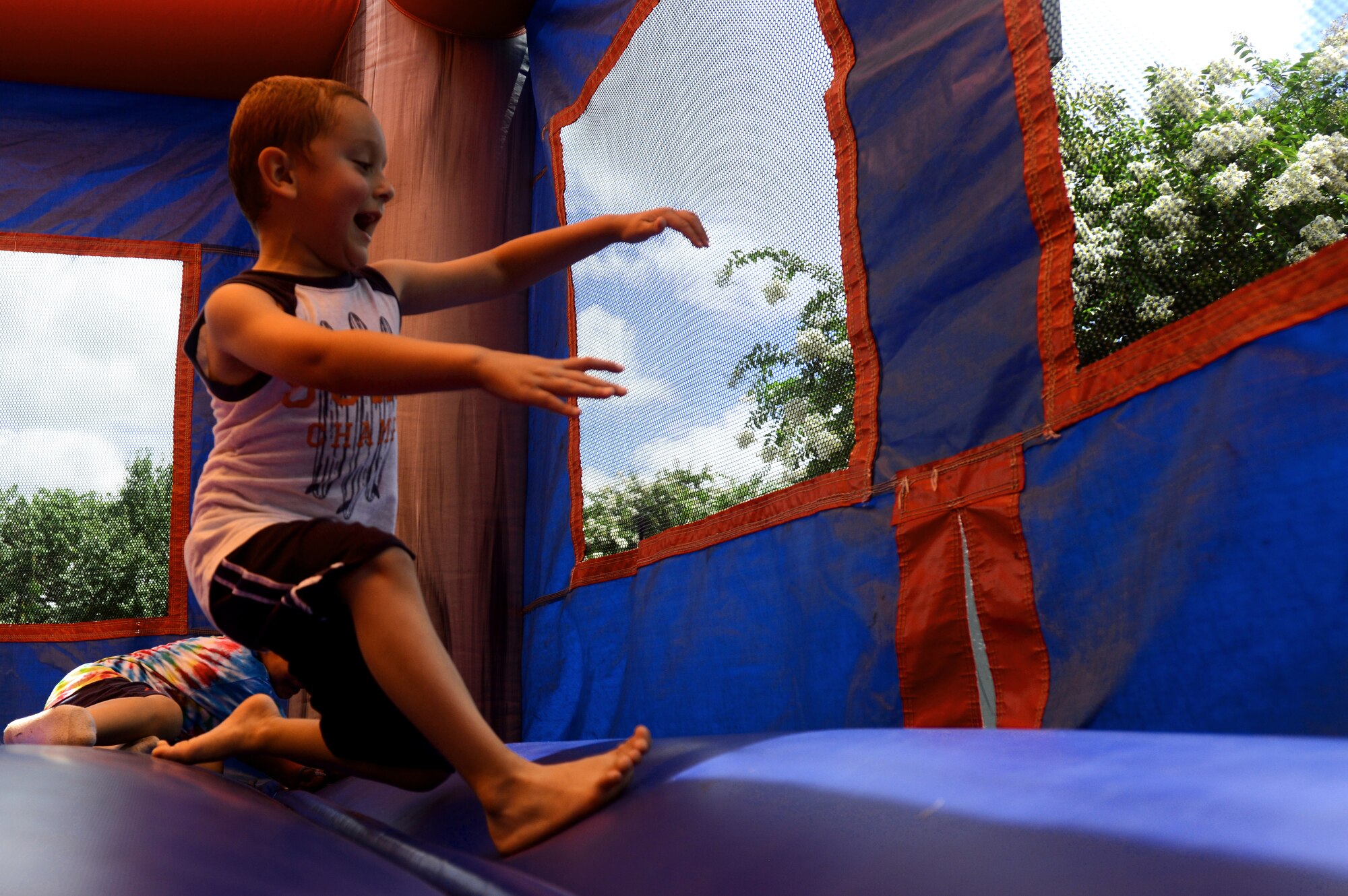 Andres Mussio runs in a bouncy castle during a Hearts Apart event at Memorial Lake Pavilion, Shaw Air Force Base, S.C., July 20 2013.  Hearts Apart events are designed to give the families of deployed or remote tour Airman a chance to have fun, relax, and network with other families.