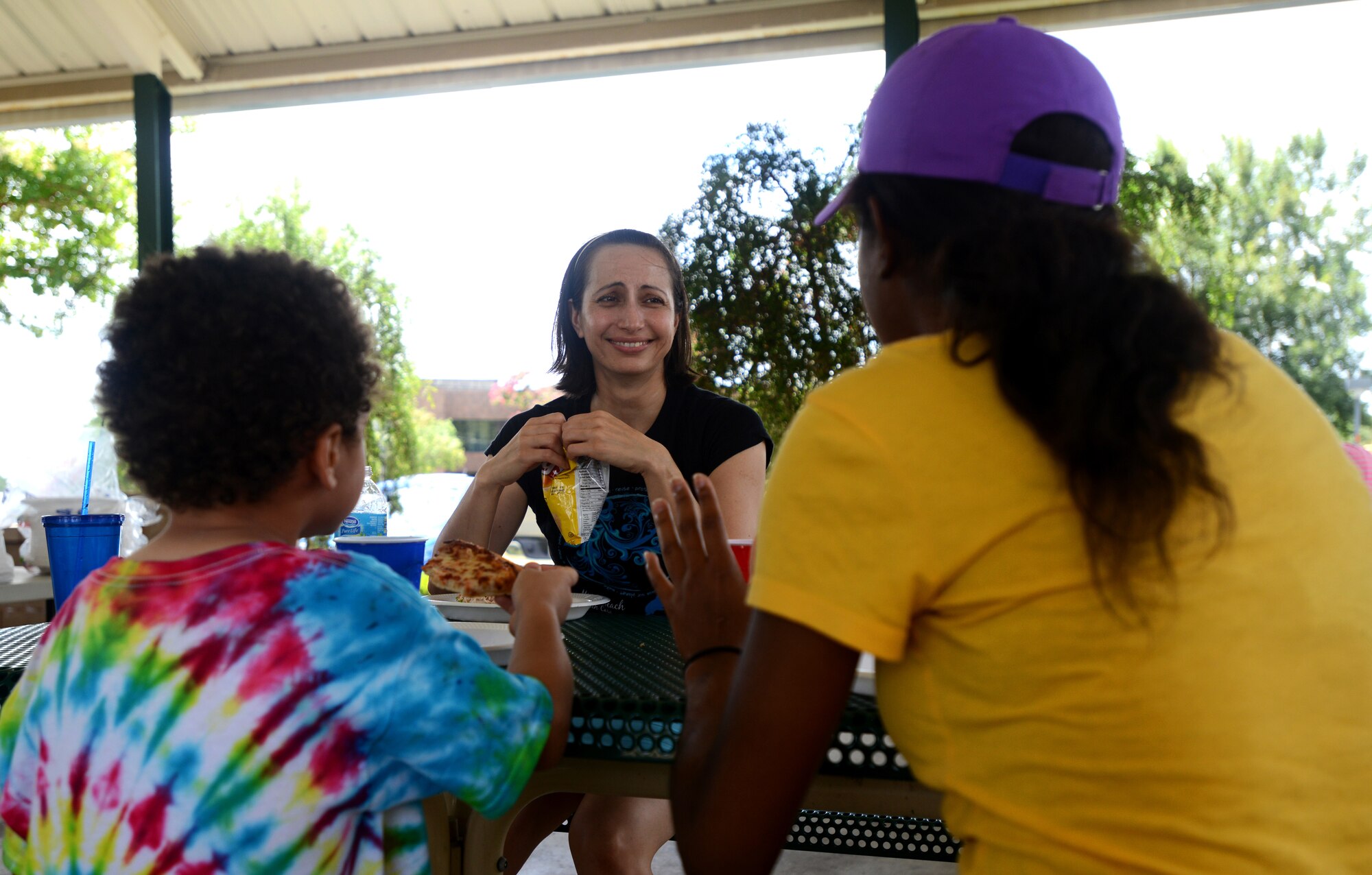 Participants of the Hearts Apart event sit and talk at Memorial Lake Pavilion, Shaw Air Force Base, S.C., July 20 2013.  Hearts Apart events give the families of deployed or remote tour Airmen a chance to have fun, relax, and network with other families.