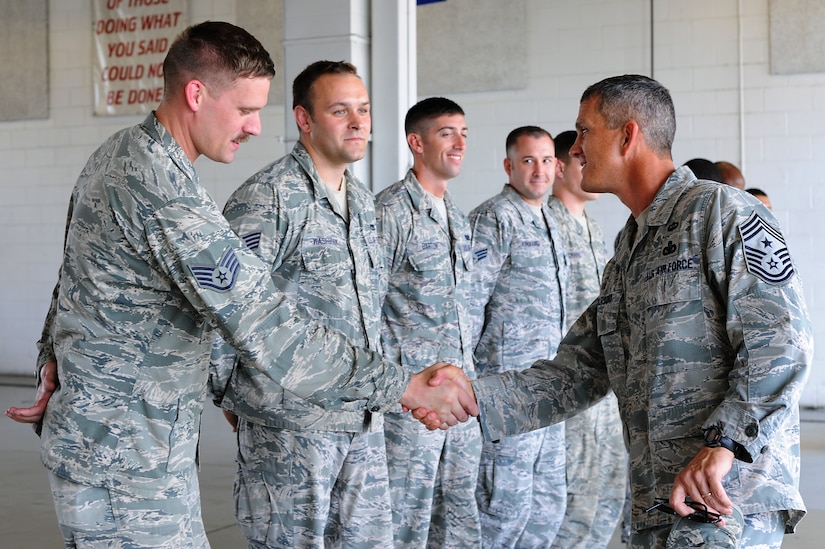 U.S. Air Force Chief Master Sgt. Richard Parsons, far right, command chief of Air Combat Command, visits with the 633rd Civil Engineer Squadron fire station at Langley Air Force Base, Va., July 17, 2013. During Parsons’ visit, he toured the building’s amenities, such as the living quarters and fitness center. (U.S. Air Force photo by Airman 1st Class Victoria H. Taylor/Released)