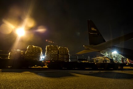 Cargo is loaded onto a C-130J-30 from Dyess Air Force Base, Texas, during an early morning cargo load July 23, 2013, at Joint Base Charleston - Air Base, S.C. The C-130J-30 was loaded with rations and supplies bound for Bogota. The C-130J-30 is a stretch version of the C-130J, a proven, highly reliable and affordable airlifter. The C-130J-30 adds 15 feet to the fuselage, increasing usable space in the cargo compartment. (U.S. Air Force photo/ Senior Airman George Goslin)