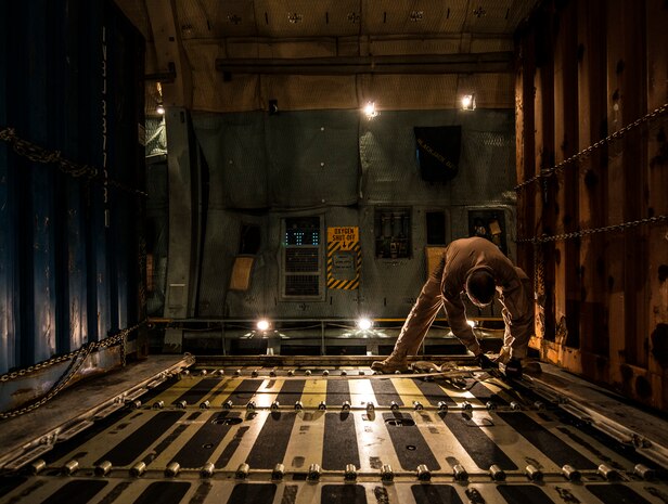 Master Sgt. David Martens, West Virginia Air National Guard member, 167th Maintenance Squadron C-5 Galaxy load master from Martinsburg, W. Va., straps down cargo on a C-5 July 22, 2013, at Joint Base Charleston – Air Base, S.C. The cargo is being used to assist operation Enduring Freedom. The C-5 is one of the largest aircraft in the world and the largest airlifter in the Air Force inventory. (U.S. Air Force photo/ Senior Airman Dennis Sloan)