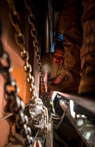 Master Sgt. John Elder, West Virginia Air National Guard member, 167th Maintenance Squadron C-5 Galaxy load master from Martinsburg, W. Va., uses chains to strap cargo to the floor of a C-5 July 22, 2013, at Joint Base Charleston – Air Base, S.C. The cargo is being used to assist operation Enduring Freedom. The C-5 is one of the largest aircraft in the world and the largest airlifter in the Air Force inventory. (U.S. Air Force photo/ Senior Airman Dennis Sloan)
