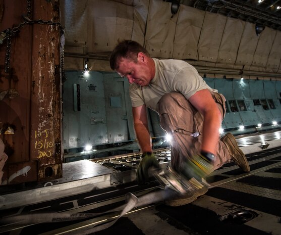 Master Sgt. John Elder, West Virginia Air National Guard member, 167th Maintenance Squadron C-5 Galaxy load master from Martinsburg, W. Va., straps down cargo July 22, 2013, at Joint Base Charleston – Air Base, S.C. The cargo is being used to assist operation Enduring Freedom. The C-5 is one of the largest aircraft in the world and the largest airlifter in the Air Force inventory. (U.S. Air Force photo/ Senior Airman Dennis Sloan)