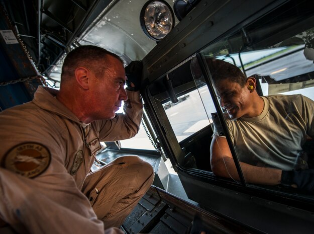 Master Sgt. David Martens, West Virginia Air National Guard member, 167th Maintenance Squadron C-5 Galaxy load master from Martinsburg, W. Va., speaks with Senior Airman Manuel Espino, 437th Aerial Port Squadron cargo loader, about loading cargo onto the C-5 July 22, 2013, at Joint Base Charleston – Air Base, S.C. The cargo is being used to assist operation Enduring Freedom. The C-5 is one of the largest aircraft in the world and the largest airlifter in the Air Force inventory. (U.S. Air Force photo/ Senior Airman Dennis Sloan)