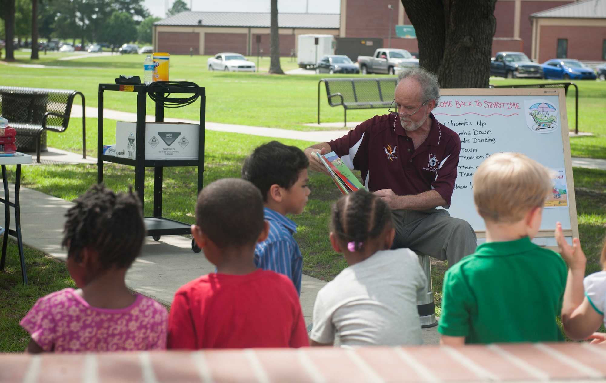 Steve Barnes, 23d Force Support Squadron library technician, reads to children during storytime at Moody Air Force Base, Ga., June 11, 2013. Storytime is held every Tuesday at 10 a.m. at the Moody Library. (U.S. Air Force photo by Senior Airman Jarrod Grammel/Released)
