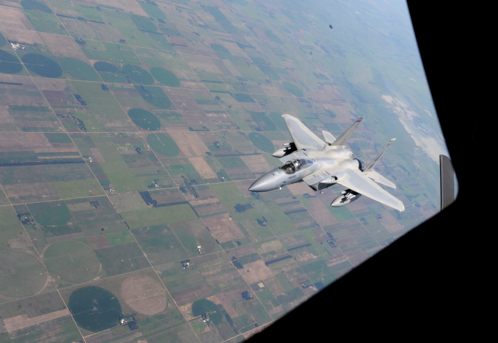After receiving fuel from a KC-135 Stratotanker assigned to McConnell Air Force Base, Kan., an F-15 Eagle from the 142nd Fighter Wing, Oregon Air National Guard, Portland, Ore., maneuvers away from the boom over northeast Kansas July 23, 2013. Three Stratotankers refueled eight F-15s during the training mission. (U.S. Air Force photo/Senior Airman Laura L. Valentine)