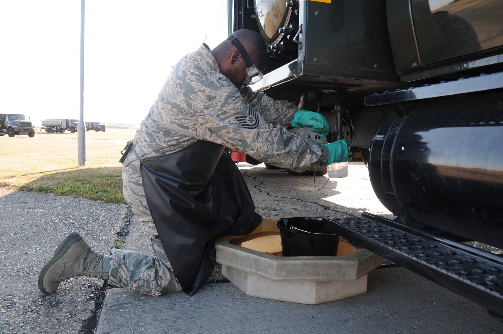 Tech. Sgt. Phillip Williams, 944th Logistics Readiness Squadron, Luke Air Force Base, Ariz., extracts a fuel sample from an R-11 refueling truck during a checkpoint inspection of the vehicle prior to the truck being used for the day, while on annual tour at RAF Mildenhall, England, July 18, 2013.  The 944th LRS worked and trained with the 100th LRS, an active duty unit stationed at RAF Mildenhall throughout the entire annual tour.  (U.S. Air Force photo/Staff Sgt. Josh Nason) 