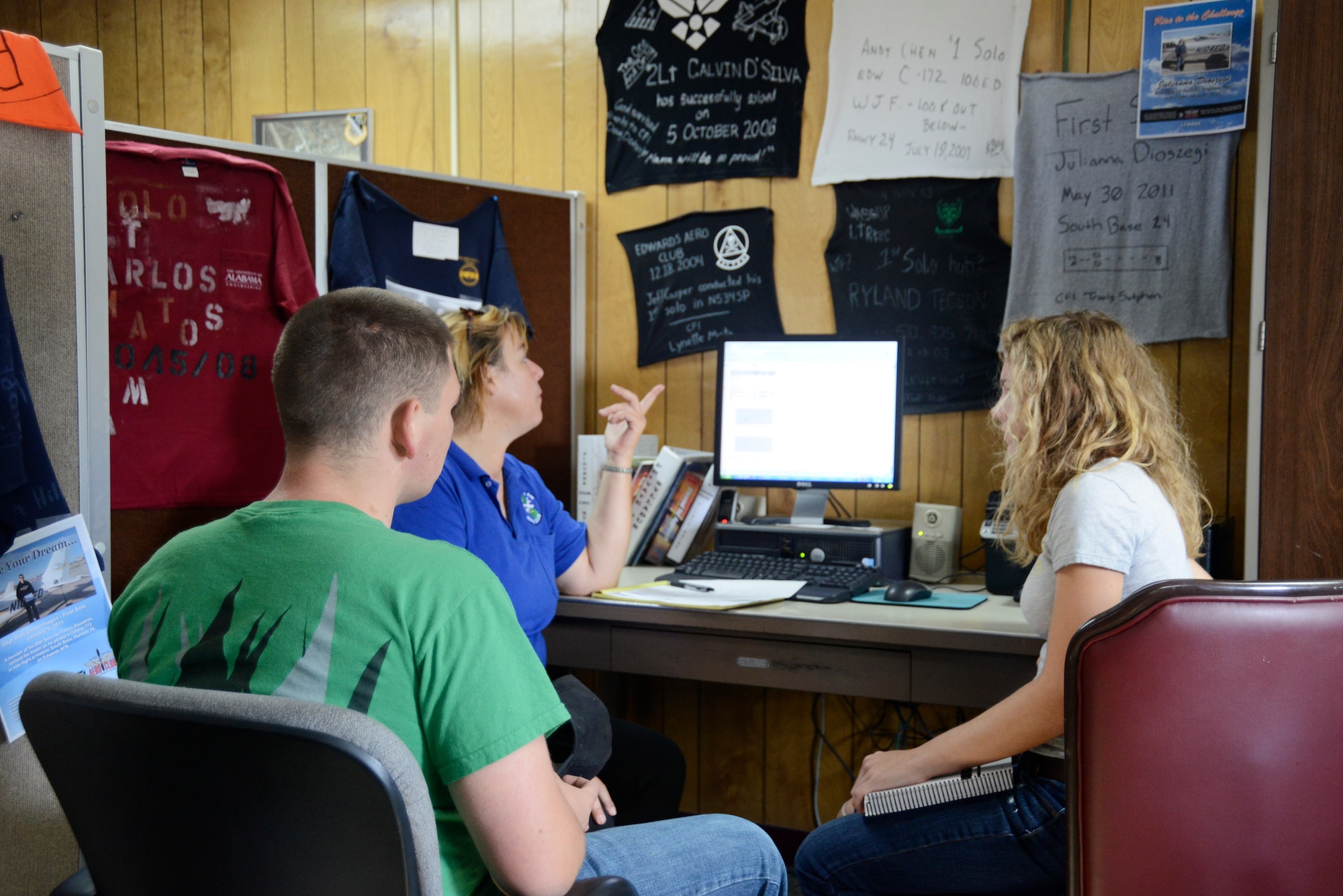 Edwards AFB Aero Club ssistant chief flight instructor, Silke Eyles (center), uses a computer program to make students familiar with the instrument panels prior to their first flight July 22. The Aero Club began its first Aero Camp for youths who are interested in learning out to fly. (U.S. Air Force photo by Rebecca Amber) 