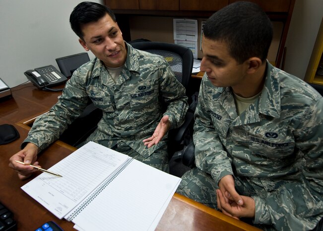 Staff Sgt. Joseph Senteno, 99th Civil Engineer Squadron budget analyst, advises an Airman on how to best use a financial document July 12, 2013, at Nellis Air Force Base, Nev. Senteno attributes much of his success to quality supervisors and strives to be the best mentor he can be. (U.S. Air Force photo by Airman 1st Class Jason Couillard) 
