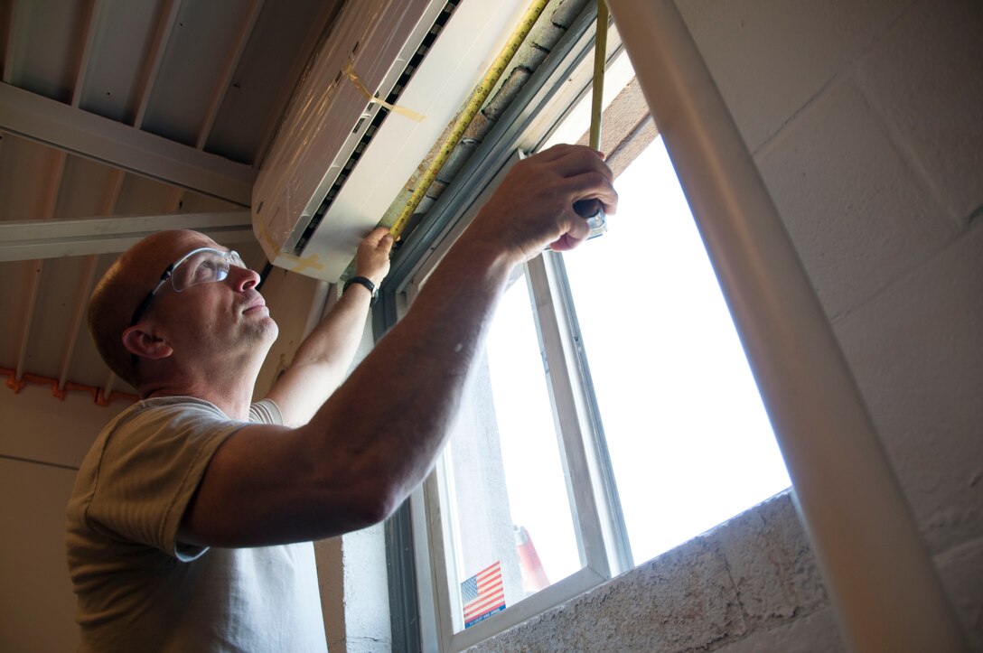 914th Civil Engineer Tech. Sgt. Terry Oathout inspects the newly installed heating and air conditioning unit in the 30th Aerial Port Squadron building at the Niagara Falls Air Reserve Station, N.Y. July 19. More than 20 Airmen of the 914th Civil Engineering Squadron repaired and updated installtion buildings during their two weeks of annual training here. (U.S. Air Force photo by Tech. Sgt. Joseph McKee)