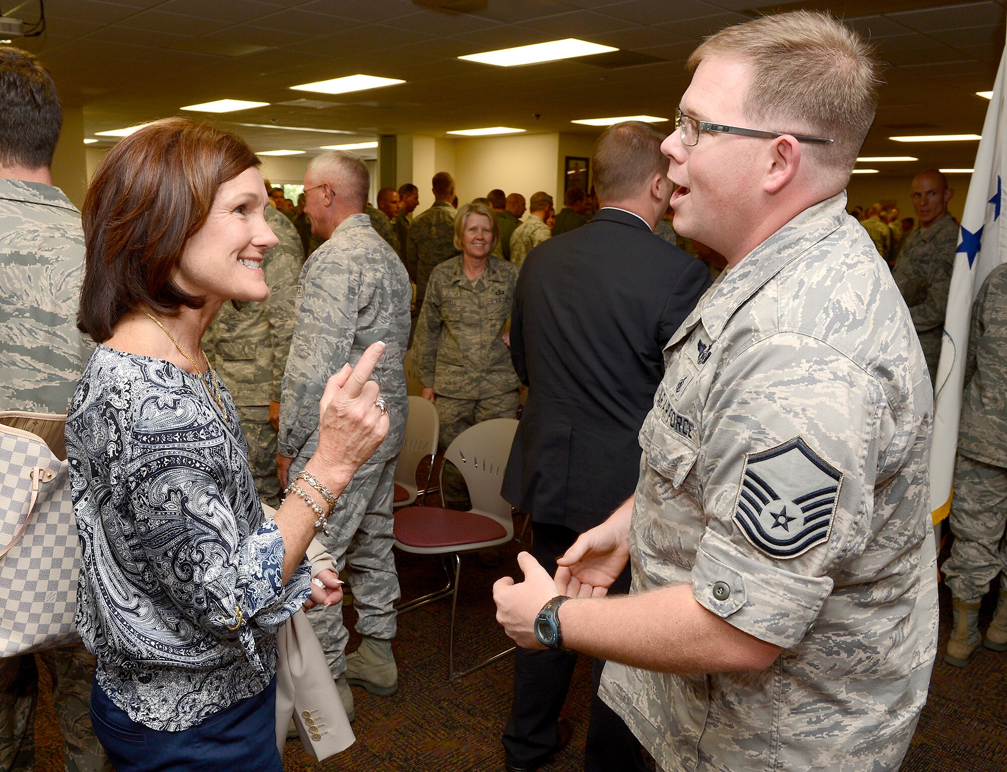 Betty Welsh, wife of Air Force Chief of Staff Gen. Mark A. Welsh III, speaks with Master Sgt. Michael Hensala, 153rd Maintenance Squadron, after an Airmen's call July 19, 2013 in Cheyenne, Wyo. The 153rd Airlift Wing hosts the Air National Guard's first active duty associate unit, the 30th Airlift Squadron.  As part of a multi-day visit to the area, the chief and Mrs. Welsh also met with commanders and spouses of the wing to thank them for their service and support and address key issues affecting the Air Force. (U.S. Air Force photo/Scott Ash)