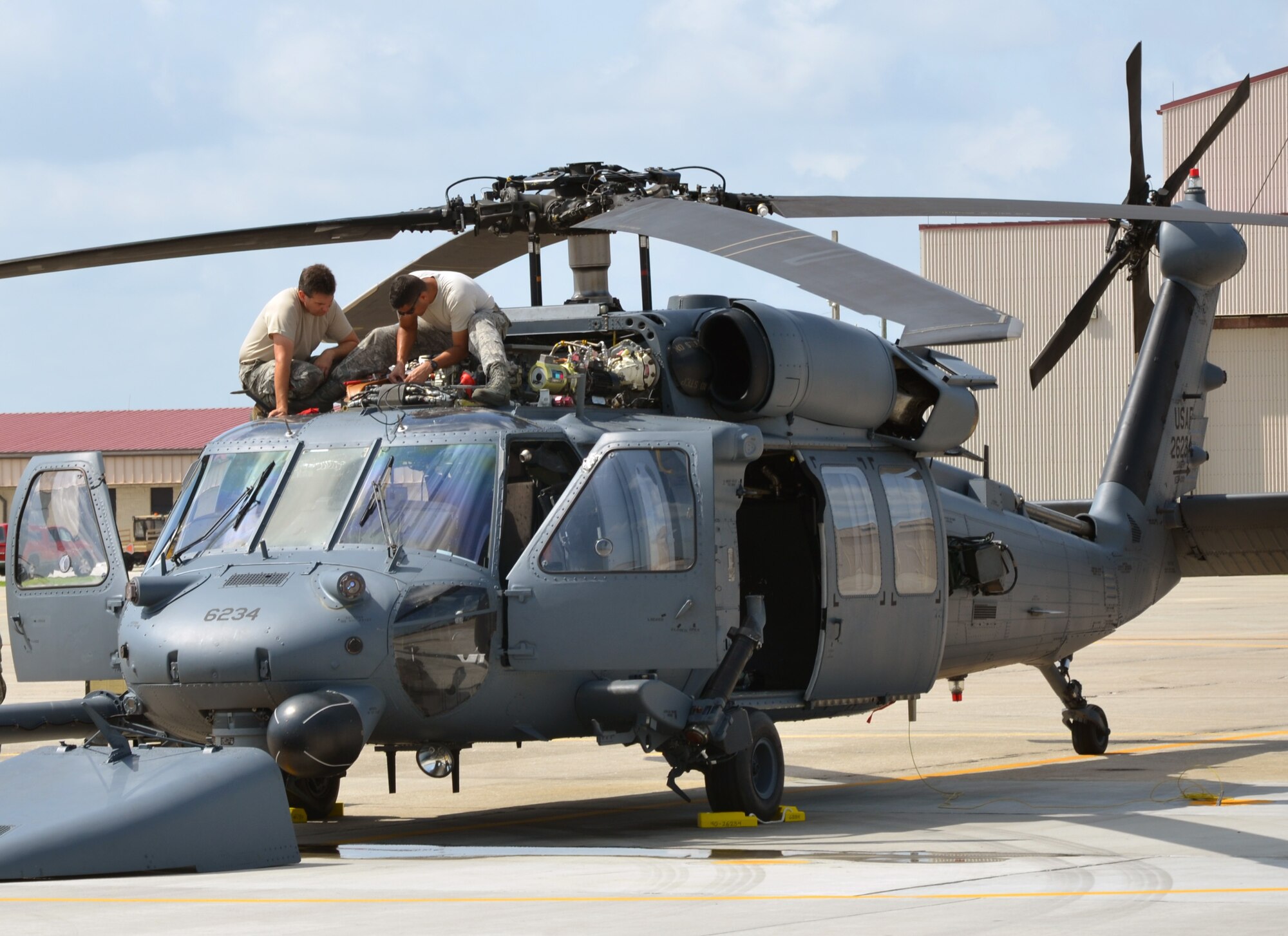 Master Sgt. Kevin Fogg (left) and Staff Sgt. Jose Zavala, 920th Maintenance Group, work on an HH-60G Pave Hawk helicopter at Patrick Air Force Base, Fla., July 24, 2013. Fogg, Zavala and fellow maintenance Airmen in the group use an innovative tracking system for all training including pre-deployment. (U.S. Air Force photo/Tech. Sgt. Anna-Marie Wyant)