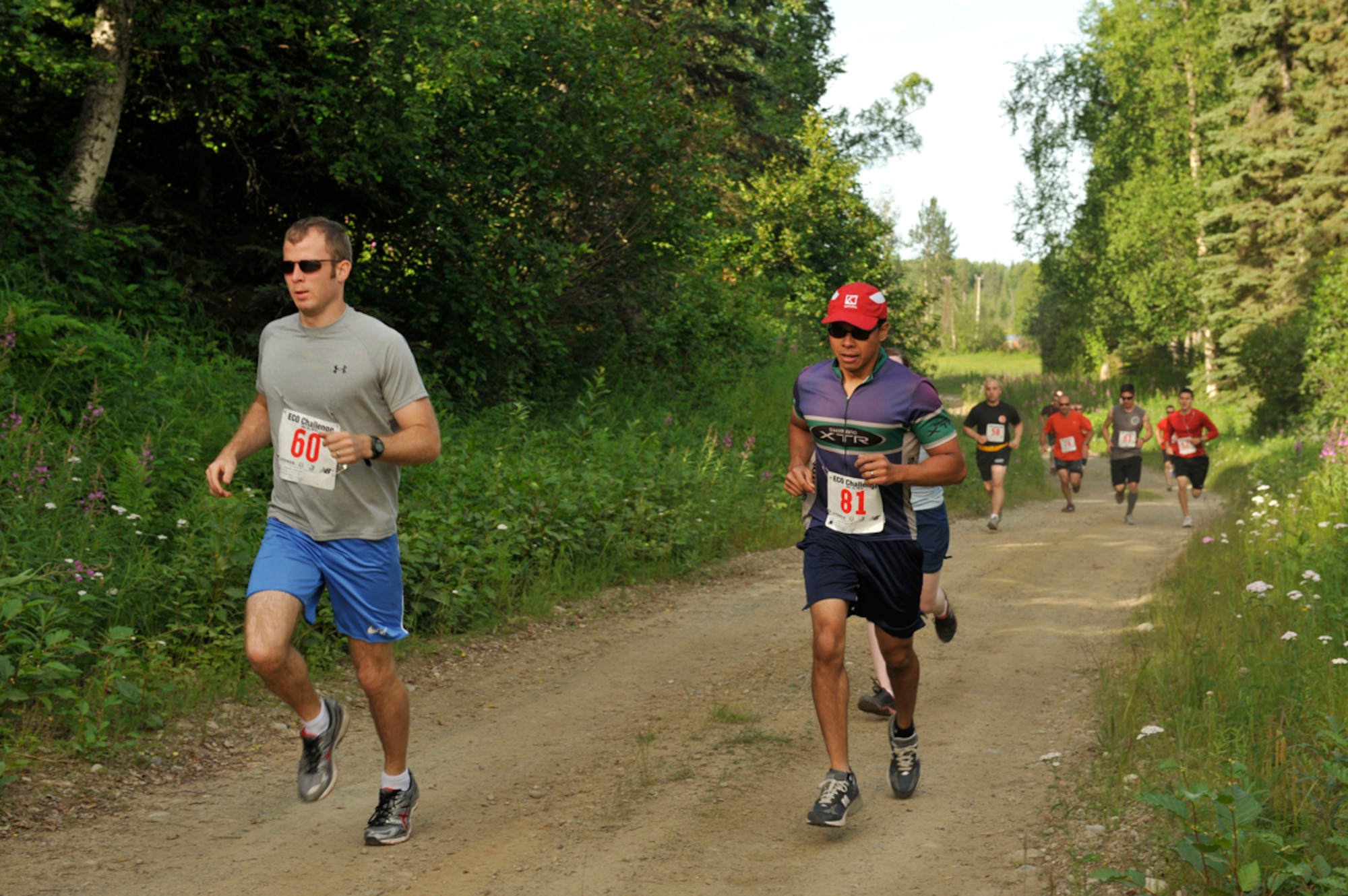 JOINT BASE ELMENDORF-RICHARDSON, Alaska-- Military members start off the Eco Challenge event with a four-and-half-mile run through the woods at Hillberg Ski Area on Joint Base Elmendorf-Richardson July 19. The Eco Challenge was a four-part event that included running, bike riding, hiking and kayaking. The purpose of the event was to get individuals outside and active. (U.S. Air Force photo/Airman 1st Class Tammie Ramsouer)