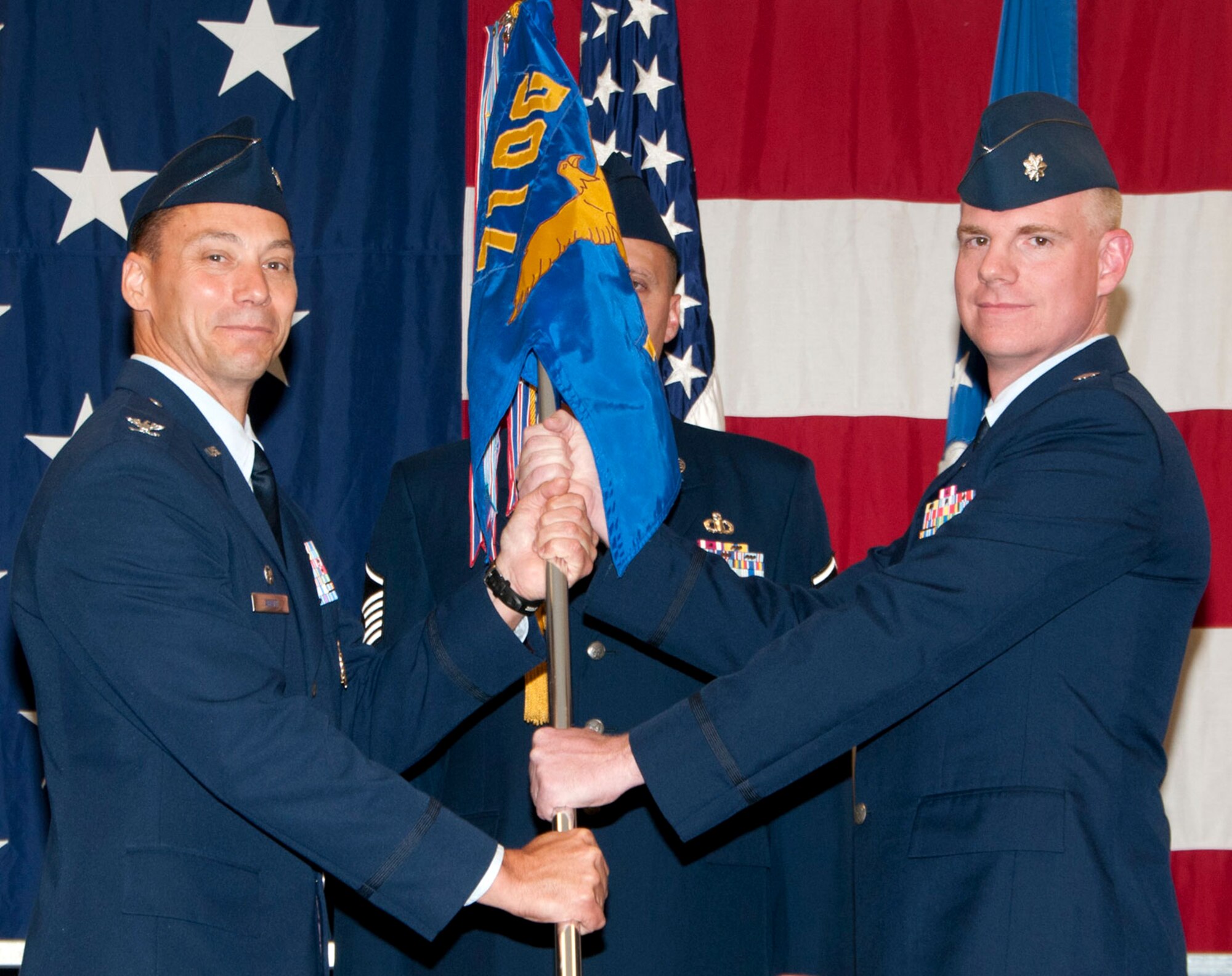 Lt. Col. David Woodley, right, accepts the 71st Operations Support Squadron guidon from Col. James Abatti, 71st Operations Group commander, during the 71st OSS change of command ceremony held June 7 in the Armed Forces Reserve Center at Vance Air Force Base, Okla. (U.S. Air Force photo/ Terry Wasson)