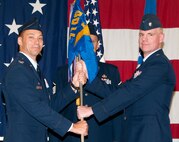 Lt. Col. David Woodley, right, accepts the 71st Operations Support Squadron guidon from Col. James Abatti, 71st Operations Group commander, during the 71st OSS change of command ceremony held June 7 in the Armed Forces Reserve Center at Vance Air Force Base, Okla. (U.S. Air Force photo/ Terry Wasson)
