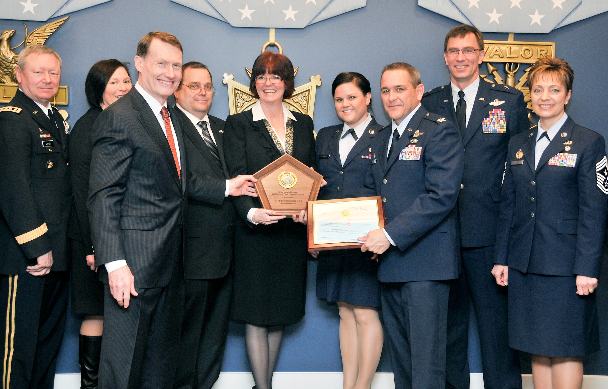 Department of Defense and National Guard leaders present the 147th Reconnaissance Wing Airman and Family Readiness Program office with the 2012 DoD Reserve Family Readiness Award for the Air National Guard during a ceremony at the Pentagon on March 1, 2013.
(From left: Gen. Frank Grass, Director NGB; Ms. Grass; Mr. John T. Hastingsl Acting Principle Deputy, Assistant Secretary of Defense for Reserve Affairs; Michael Norton; Ms. Monalisa Norton, 147RW Airman and Family Readiness Program Manager (FRG); Staff Sgt. Holly Yeagley, 147RW FRG Assistant; Col. John Daniel, Commander 147RW; Brig. Gen Kenneth Wisian, Commander Texas Air National Guard; Chief Master Sgt. Denise M. Jelinski-Hall, Senior Enlisted Leader for the National Guard Bureau) (National Guard Photo by Master Sgt. Sean Cowher)