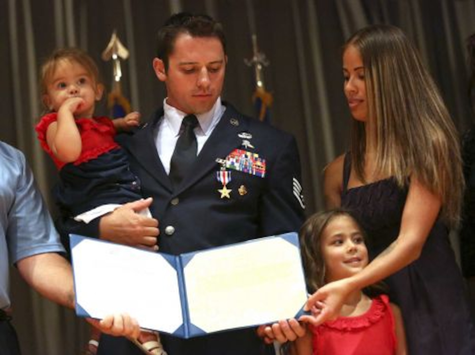 Staff Sgt. Dale Young, 29, holds his daughter Karina while standing next to his oldest daughter Ariana and wife Rayna.(Photo By Helen L. Montoya/San Antonio Express-News)