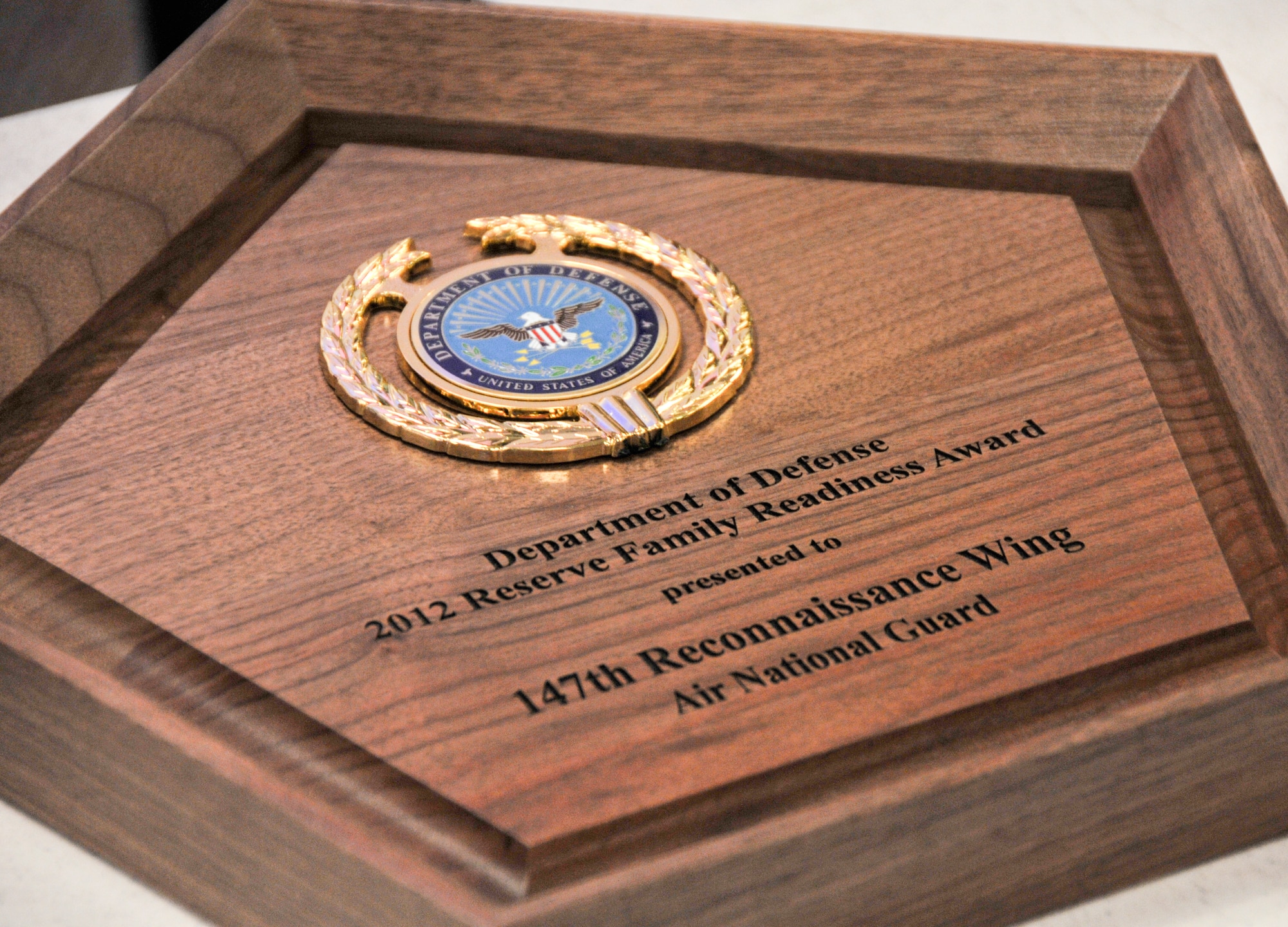 The plaque awarded to the 147th Reconnaissance Wing Airman and Family Readiness Program Office during the 2012 Department of Defense Reserve Family Readiness Award Ceremony at the Pentagon on March 1, 2013. The 147th RW Family Readiness Office was named best in the Air National Guard for 2012. (National Guard Photo by MSgt Sean Cowher)