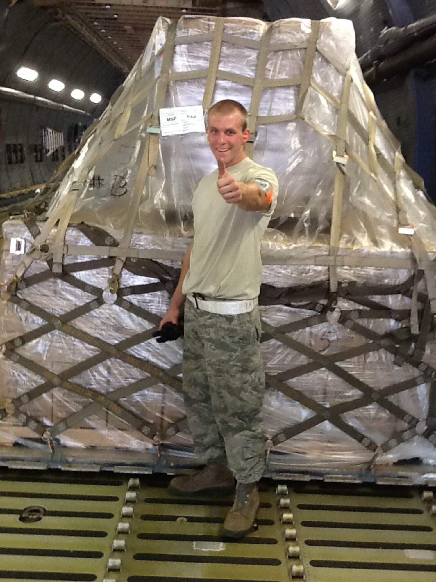 Senior Airman Tanner Ladsen, 27th Aerial Port Squadron, gives "thumbs up" after loading a pallet of food and supplies for a Denton Cargo mission. (Courtesy Photo)