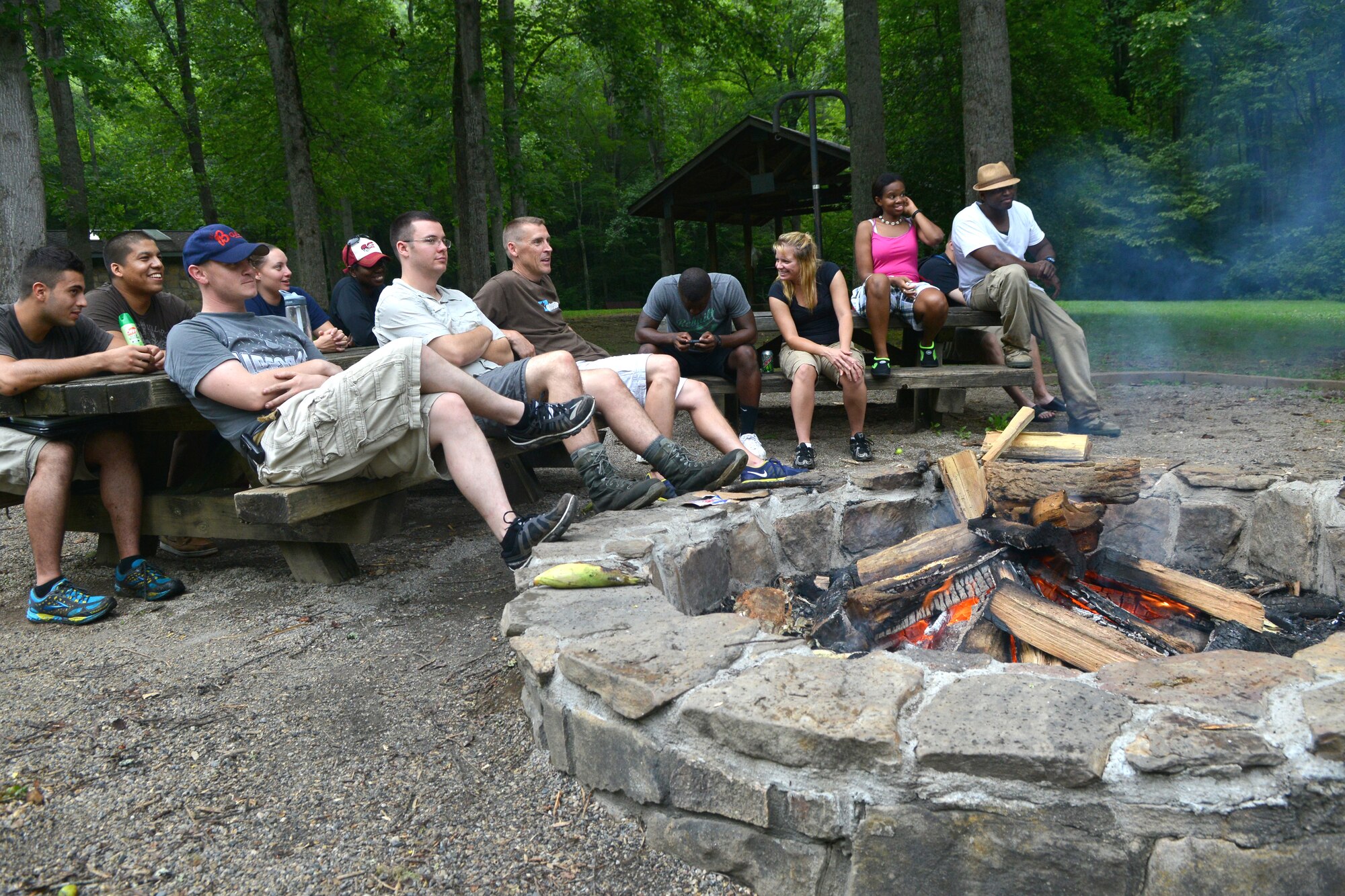 A group of Airmen gather around a campfire sharing life stories during a white-water rafting trip, Bryson City, N.C., July 21, 2013. The chapel sponsored the out-of-town opportunity for Team Shaw single service members to focus on resiliency, physical challenge and social growth. (U.S. Air Force photo by Airman 1st Class Ashley L. Gardner/Released)