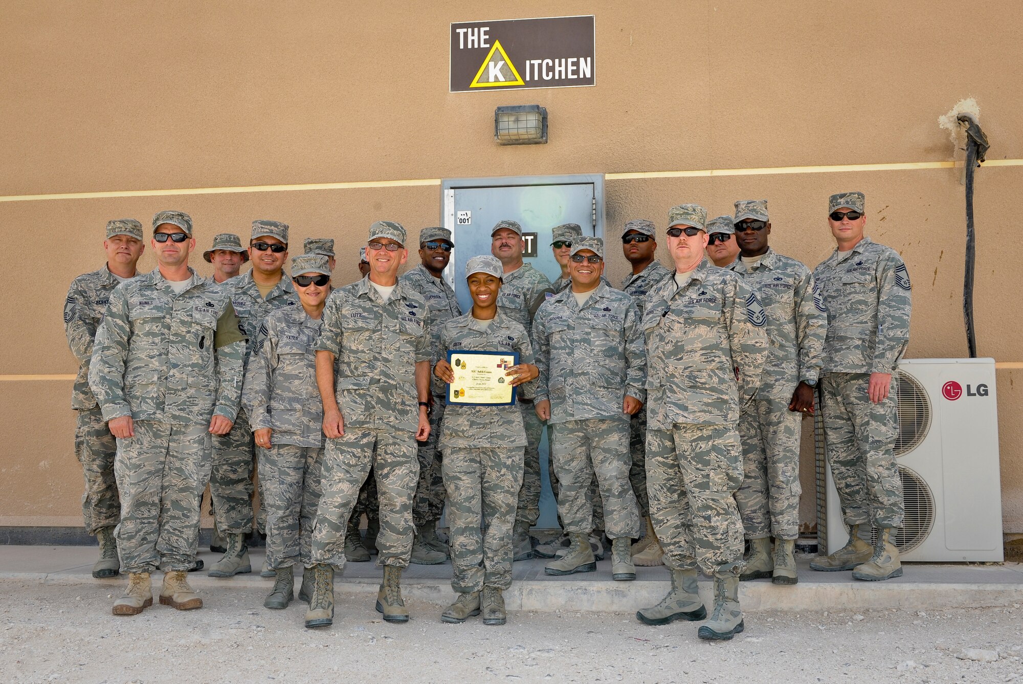Airman 1st Class Ashli Green poses with members of the Desert Chiefs Group following her recognition for superior performance at the 379th Air Expeditionary Wing in Southwest Asia, July 22, 2013. Green is a 379th Expeditionary Force Support Squadron quality assurance evaluator deployed from Joint Base Charleston, S.C. (U.S. Air Force photo/Senior Airman Benjamin Stratton)