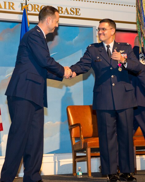 Col L. Dean Worley, right, former commander of the 461st Air Control Wing , congratulates Col. Henry Cyr during a change of command ceremony at the Century of Flight Hangar, Museum of Aviation, Warner Robins, Ga., July 23, 2013. During the ceremony, Worley relinquished command of the 461st ACW to Cyr who takes over after serving as vice commander of the wing for the past two years. (U.S. Air National Guard photo by Master Sgt. Roger Parsons/Released)