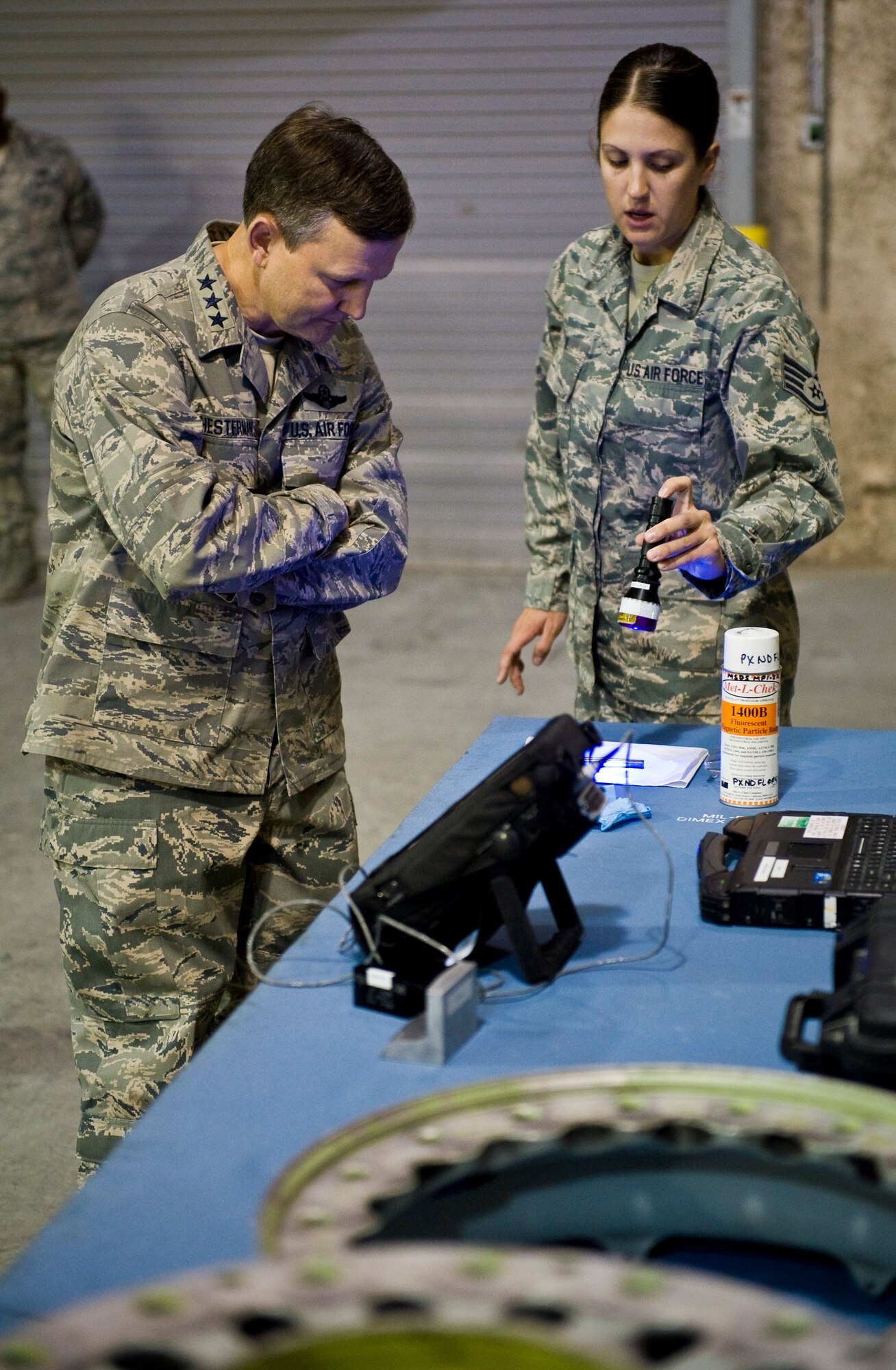 Staff Sgt. Krystal Aqui shows Lt. Gen. John W. Hesterman III her job and what she does to support the mission at the 379th Air Expeditionary Wing in Southwest Asia, July 23, 2013. Aqui is a 379th Expeditionary Maintenance Squadron non-destructive inspection technician deployed from Barksdale Air Force Base, La. Hesterman is the Combined Force Air Component Commander responsible for developing contingency plans and conducting air operations in a 20-nation area of responsibility covering Central and Southwest Asia. (U.S. Air Force photo/Senior Airman Benjamin Stratton)