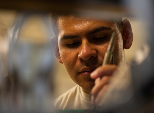 Senior Airman Matthew Garcia, 8th Communications Squadron Airfield Systems technician, inspects computer hardware using an oscilloscope to ensure proper signals and voltage at Kunsan Air Base, Republic of Korea, July 24, 2013. Garcia was named Kunsan’s “Pride of the Pack” winner June 24 - 30, 2013. (U.S. Air Force photo by Senior Airman Armando A. Schwier-Morales/ Released) 