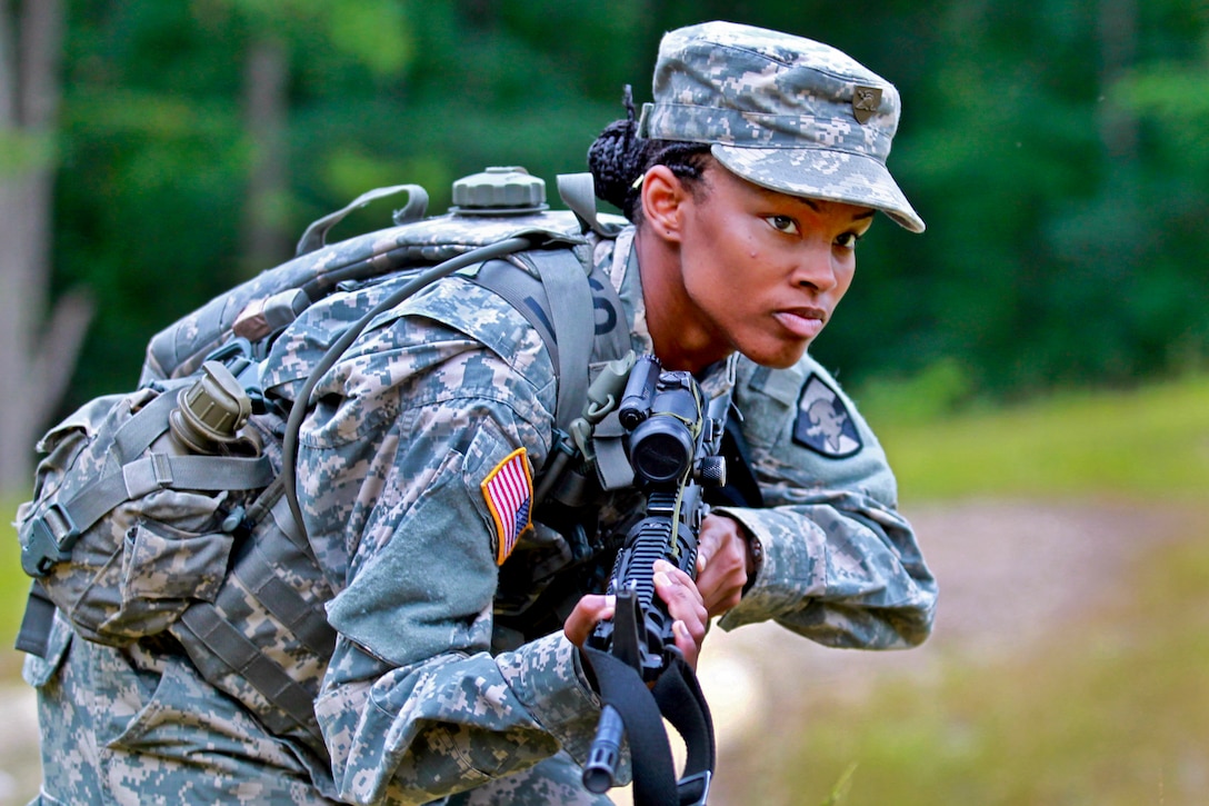 U.S. Military Academy Cadet Dartie Gilet moves along the road as members of her platoon take on the Urban Assault Course phase of training on Camp Buckner in West Point, N.Y., July 11, 2013.