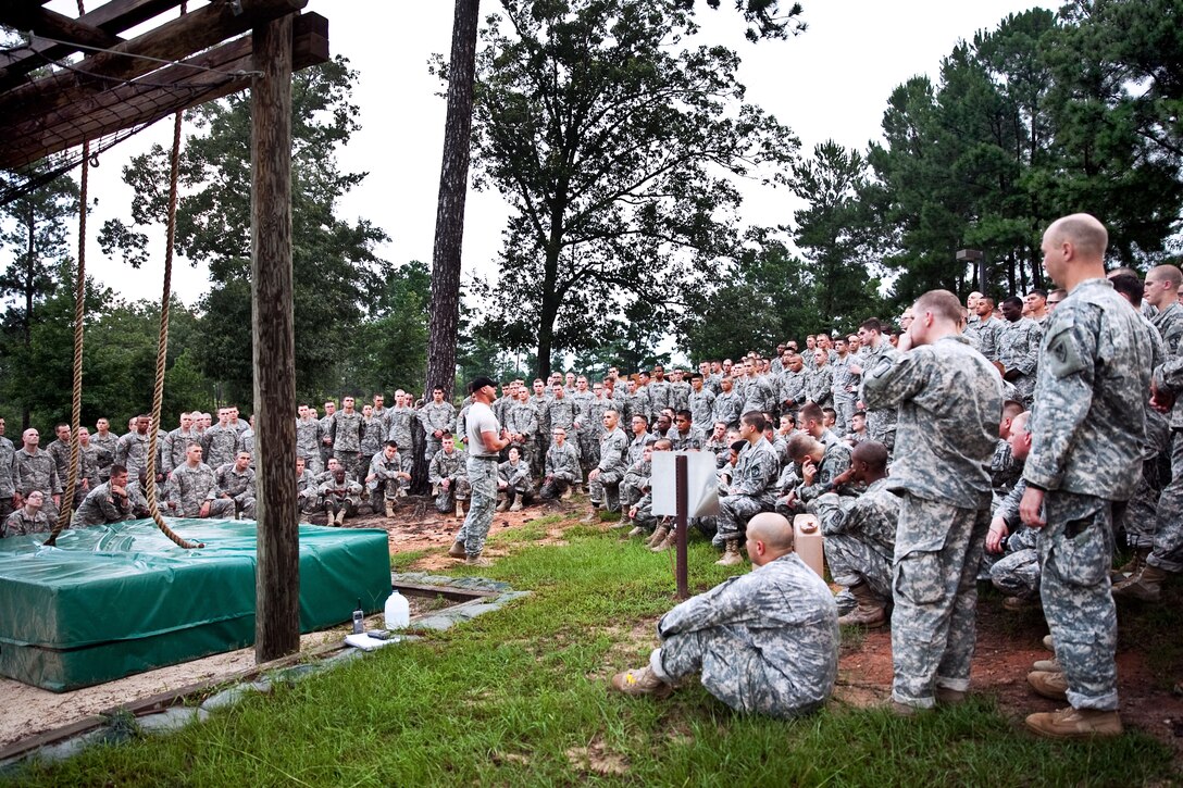 Army Staff Sgt. Derek Koth, center, explains how to negotiate the