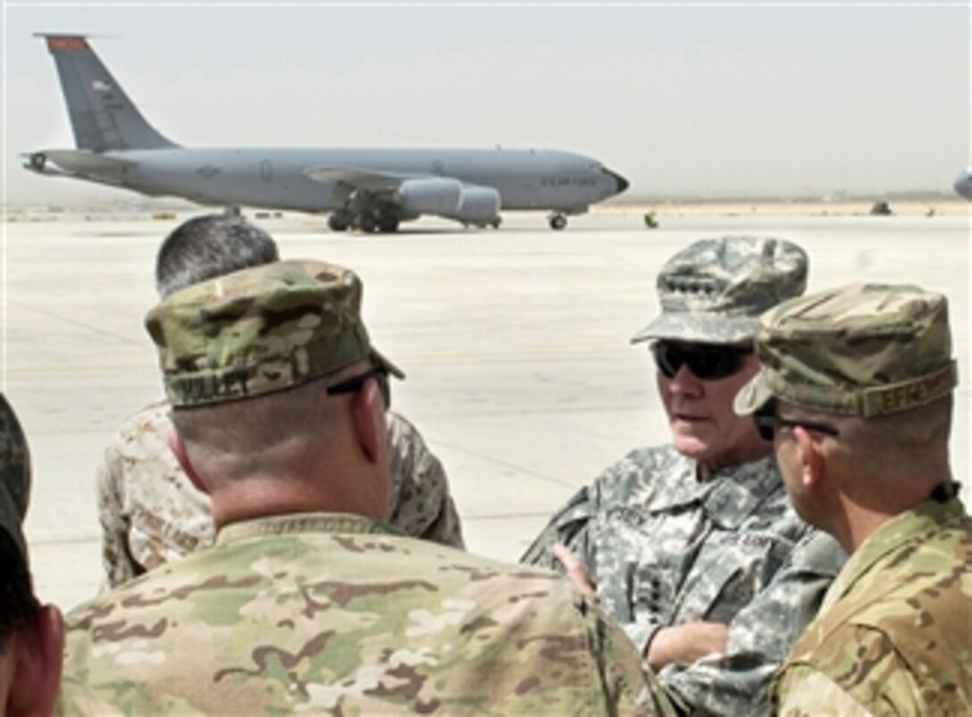 Chairman of the Joint Chiefs of Staff Gen. Martin E. Dempsey, second from right, talks with RC-North leadership about the KC-135 Stratotanker aircraft mission on the flight line in Mazar-e-Sharif, Afghanistan, on July 21, 2013.  Dempsey is in Afghanistan to meet Afghan senior leaders, NATO members, U.S. leadership and U.S. troops deployed there.  The Stratotanker provides mid-air refueling to long-range bomber, fighter and cargo aircraft.  