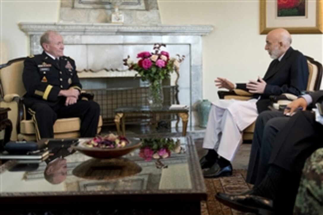 Afghanistan President Hamid Karzai, right, meets with Chairman of the Joint Chiefs of Staff Gen. Martin E. Dempsey, left, at the Presidential Palace in Kabul, Afghanistan, on July 22, 2013.  Dempsey is in Afghanistan to meet Afghan senior leaders, NATO members, U.S. leadership and U.S. troops deployed there.  