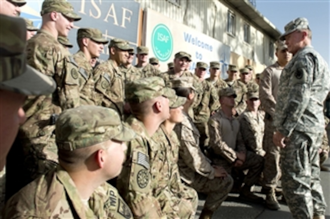 Chairman of the Joint Chiefs of Staff Gen. Martin E. Dempsey, right, talks with a group of soldiers and Marines stationed at the International Security Assistance Force Headquarters at Camp Eggers in Kabul, Afghanistan, on July 22, 2013.  Dempsey is in Afghanistan to meet Afghan senior leaders, NATO members, U.S. leadership and U.S. troops deployed there.  
