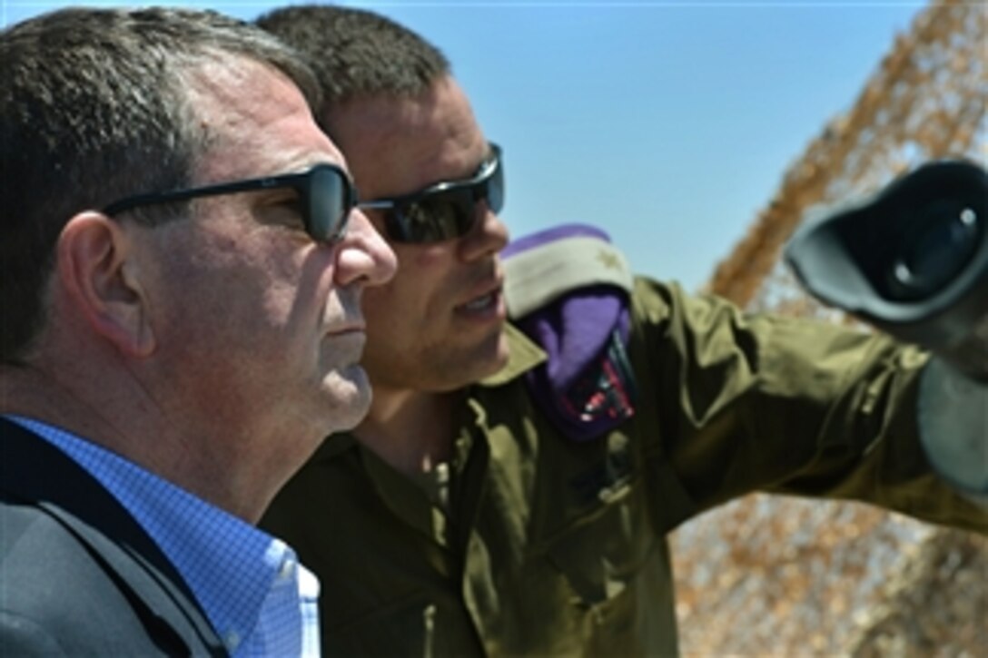 Deputy Secretary of Defense Ashton B. Carter listens as an Israeli soldier highlights points of interest at the Northern Israeli Outpost in Israel on July 22, 2013.  Carter is on his first official trip to Israel where he will discuss the situations in Syria and Iran and reaffirm the U.S.-Israeli defense relationship.  
