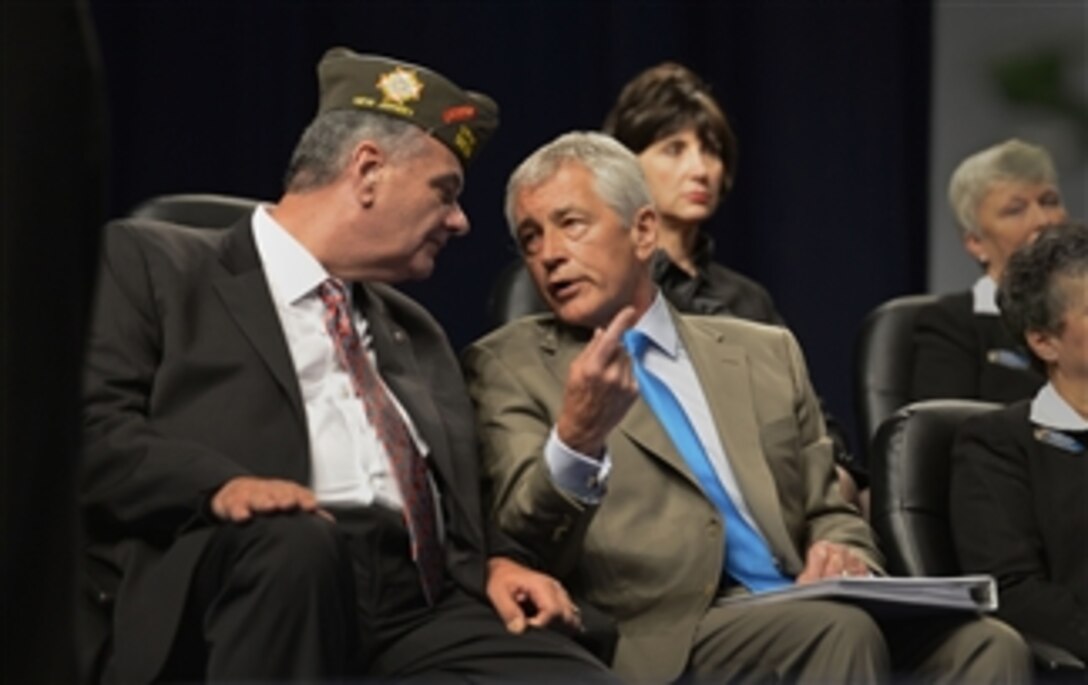 Secretary of Defense Chuck Hagel, right, speaks with Veterans of Foreign Wars Assistant Adjunct General Robert Wallace, left, shortly before addressing the attendees of the VFW National Convention held at the Louisville International Convention Center in Louisville, Ky., on July 22, 2013.  