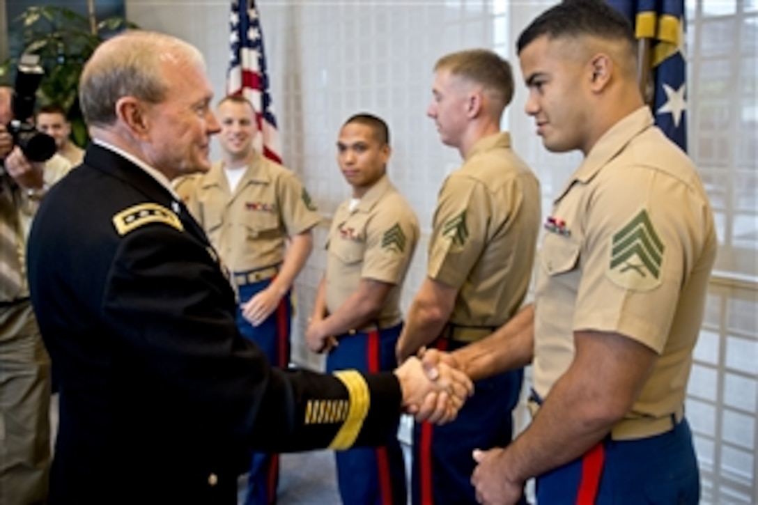 U.S. Army Gen. Martin E. Dempsey, chairman of the Joint Chiefs of Staff, shakes hands with U.S. Marines at the U.S. Embassy in Warsaw, Poland, July 24, 2013. Dempsey traveled to Poland after spending three days in Afghanistan.