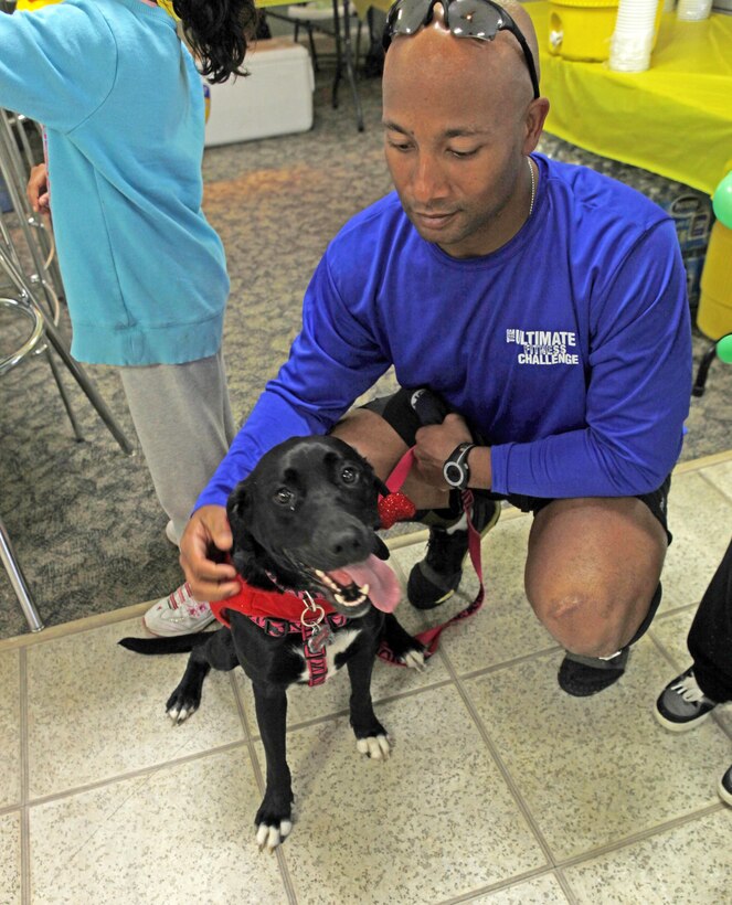 A service member and his beloved pooch enjoy the festivities at the Paws in the Park event at the Midway Park Community Center aboard Marine Corps Base Camp Lejeune April 20.