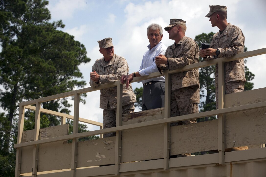 Secretary of Defense Chuck Hagel speaks with Marine Corps Base Camp Lejeune leaders from an over watch position at Military Operations on Urban Terrain Town during his visit to the base, July 17. Hagel completed his tour by visiting Marine Corps Special Operations Command, students of School of Infantry East and having a roundtable discussion with female Marines regarding their roles in combat areas.


