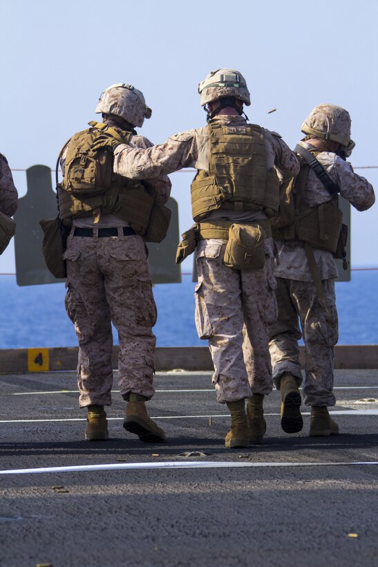 U.S. Marines assigned to Combat Logistics Battalion 26, 26th Marine Expeditionary Unit (MEU), conduct a Table 3 live-fire exercise on the flight deck of the USS Kearsarge (LHD 3), at sea, July 25, 2013. The 26th MEU is a Marine Air-Ground Task Force forward-deployed to the U.S. 5th Fleet area of responsibility aboard the Kearsarge Amphibious Ready Group serving as a sea-based, expeditionary crisis response force capable of conducting amphibious operations across the full  range of military operations. (U.S. Marine Corps photo by Cpl. Kyle N. Runnels/Released)