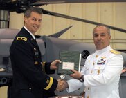 Brigadier General Daniel Hokanson, Deputy Director for Strategy, Policy & Plans (J5) USNORTHCOM, presents the keys and the aircraft log book to Rear Admiral Jorge Carlos Morales, Director of Naval Aviation, Mexico, during a ceremony marking the turnover of three UH-60 Helicopters to the Mexican Navy. The US Government provided thee UH-60 helicopters to the Mexican Navy as part of the Merida Initiative. The ceremony was held on August 24, 2011 at Joint Base McGuire-Dix-Lakehurst, NJ.
