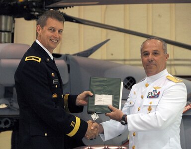 Brigadier General Daniel Hokanson, Deputy Director for Strategy, Policy & Plans (J5) USNORTHCOM, presents the keys and the aircraft log book to Rear Admiral Jorge Carlos Morales, Director of Naval Aviation, Mexico, during a ceremony marking the turnover of three UH-60 Helicopters to the Mexican Navy. The US Government provided thee UH-60 helicopters to the Mexican Navy as part of the Merida Initiative. The ceremony was held on August 24, 2011 at Joint Base McGuire-Dix-Lakehurst, NJ.
