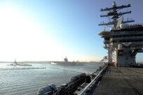 The aircraft carrier USS Dwight D. Eisenhower (CVN 69) departs Naval Station Norfolk ahead of Hurricane Irene. Vice Adm. Daniel Holloway, commander of U.S. 2nd Fleet, ordered all ships in the Hampton Roads area to set Sortie Condition Alpha. Ships in the area are departing early Thursday morning, Aug. 25. Irene's current track indicates it will pass off the North Carolina and Virginia coasts late Saturday as a Category 3 hurricane. 