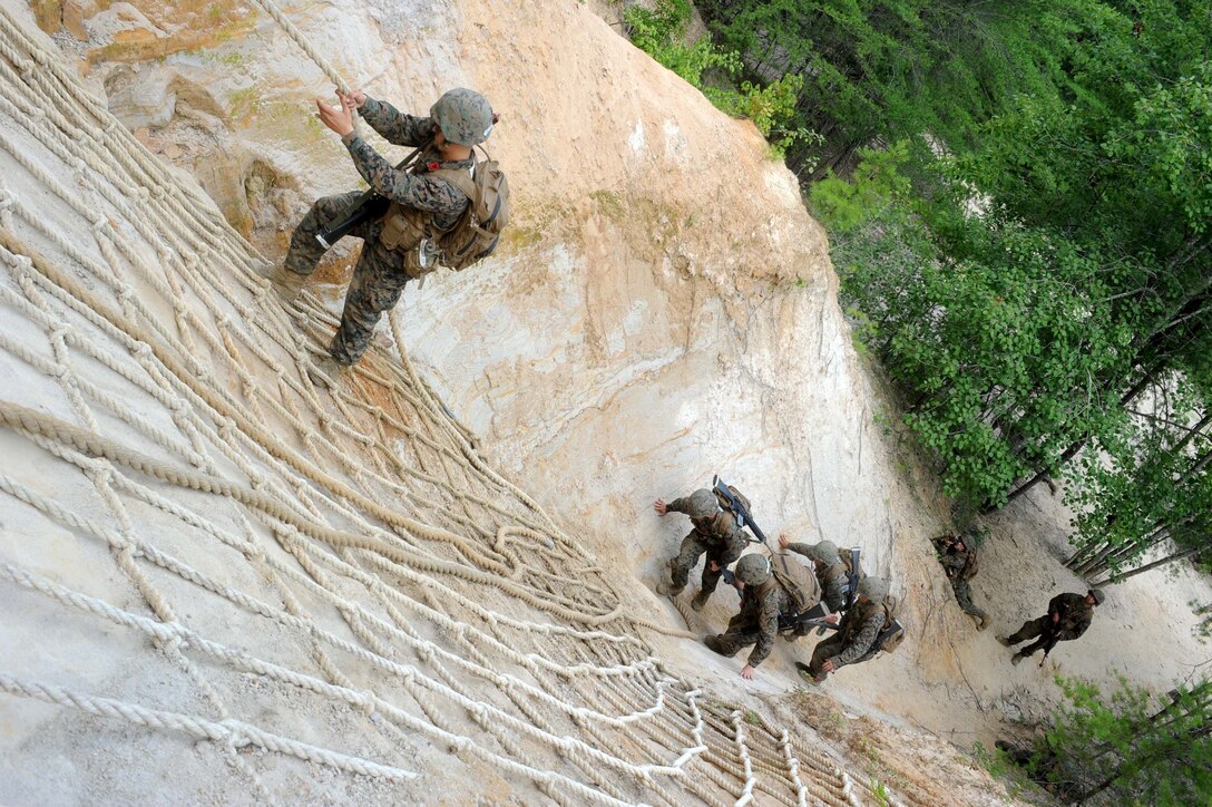 Charlie Co. candidates from the Officer Candidates School, participate in a medical evacuation exercise during a second Small Unit Leadership Evaluation aboard Marine Corps Base Quantico on July 25, 2013. The event evaluates leadership, command presence, communication and decision making.