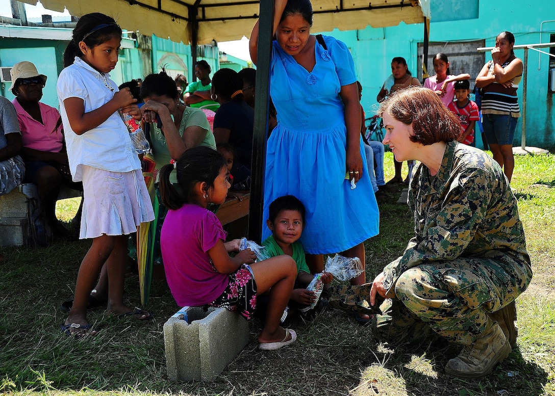 U.S. Marine Corps Sgt. Claire Boswell, a civil affairs noncommissioned officer from Joint Base Anacostia-Bolling, Washington D.C., talks with Belizean children during a dental readiness training exercise at the Punta Gorda Hospital Annex, April 26.  Dental professionals from the U.S. and Canada are providing free dental treatment at multiple readiness training exercises throughout Belize as part of exercise New Horizons. (U.S. Air Force photo by Tech Sgt. Tony Tolley/Released)